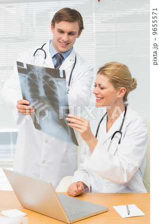 Happy doctors examining an xray together 9655571