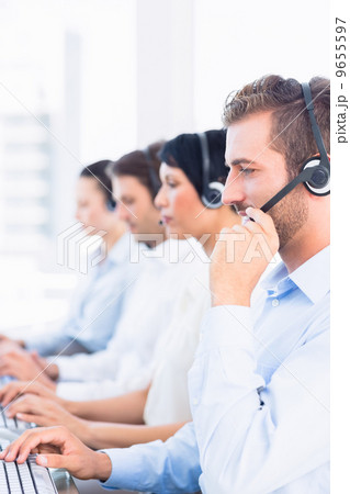 Business colleagues with headsets in a row Business colleagues with headsets in a row 9655597
