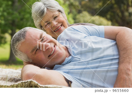 Close-up portrait of a senior couple lying at park 9655660