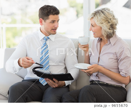Businessman and his secretary with diary and tea cup 9655670