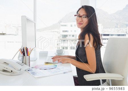 Female photo editor working on computer Female photo editor working on computer 9655983