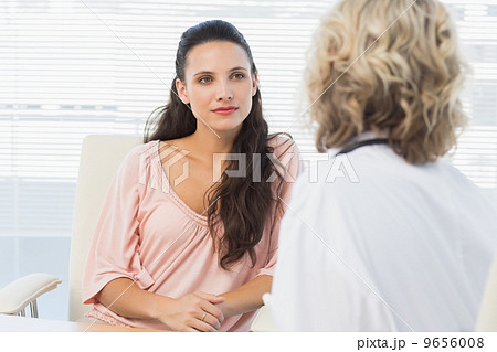 Female patient listening to doctor with concentration in medical 9656008