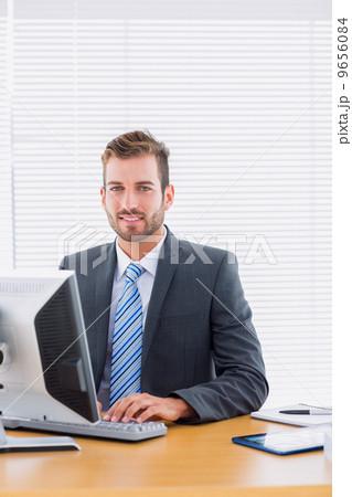 Businessman using computer at office desk Businessman using computer at office desk 9656084