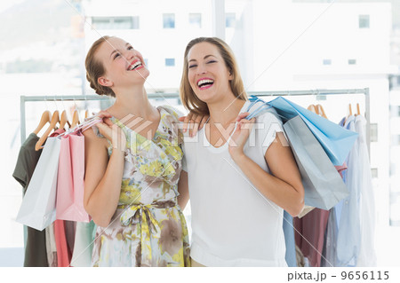 Cheerful women with shopping bags in the clothes store Cheerful women with shopping bags in the clothes store 9656115