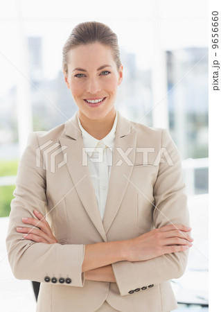 Portrait of a young businesswoman with arms crossed smiling Portrait of a young businesswoman with arms crossed smiling 9656660