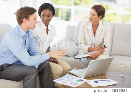 Business team meeting to go over numbers on the couch 9656922