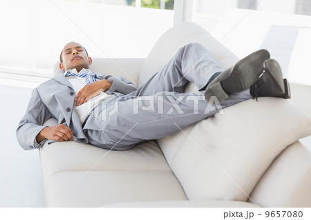 Businessman napping on the couch 9657080