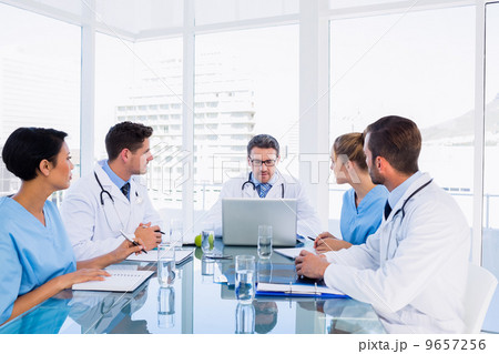 Concentrated medical team around desk 9657256