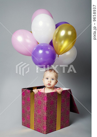 cute little girl sitting on box with balloons cute little girl sitting on box with balloons 9658937