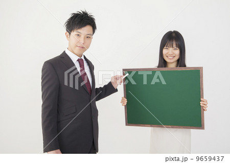 黒板で説明するビジネス男女 9659437