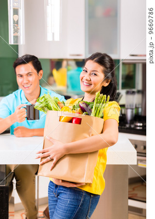 Asian woman coming home from grocery shopping 9660786