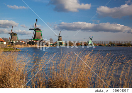 Traditional Dutch windmills with canal in Zaanse Schans near the Amsterdam, Holland 9660897
