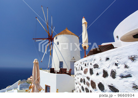 Santorini island with windmills in Greece 9660934