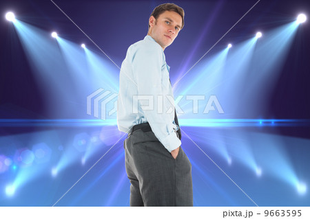 Composite image of serious businessman standing with hands in po Composite image of serious businessman standing with hands in po 9663595