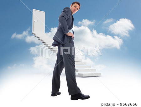 Composite image of serious businessman with hands on hips Composite image of serious businessman with hands on hips 9663666