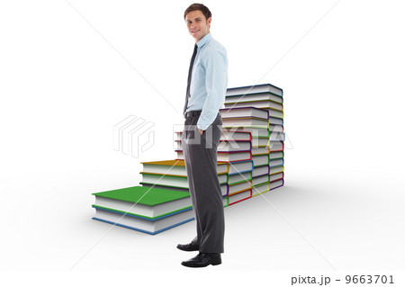 Composite image of smiling businessman standing with hands in po Composite image of smiling businessman standing with hands in po 9663701