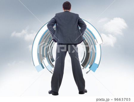 Composite image of businessman standing with hands on hips Composite image of businessman standing with hands on hips 9663703