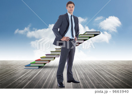 Composite image of serious businessman with hands on hips Composite image of serious businessman with hands on hips 9663940