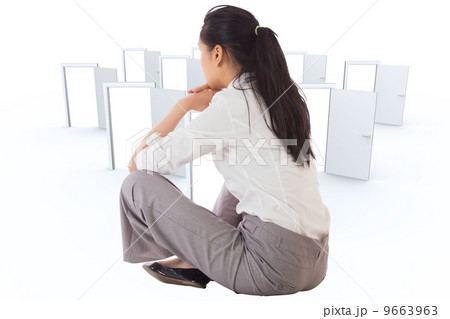 Composite image of businesswoman sitting cross legged Composite image of businesswoman sitting cross legged 9663963