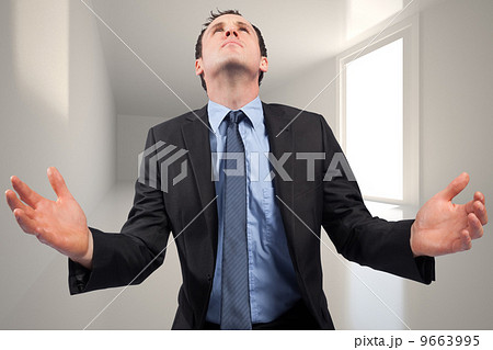 Composite image of businessman posing with arms out 9663995