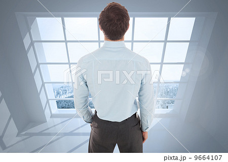 Composite image of businessman standing with hand in pocket Composite image of businessman standing with hand in pocket 9664107