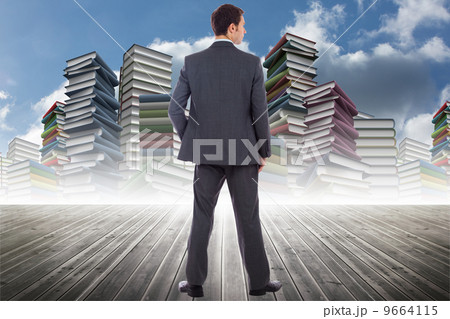 Composite image of serious businessman with hand in pocket 9664115