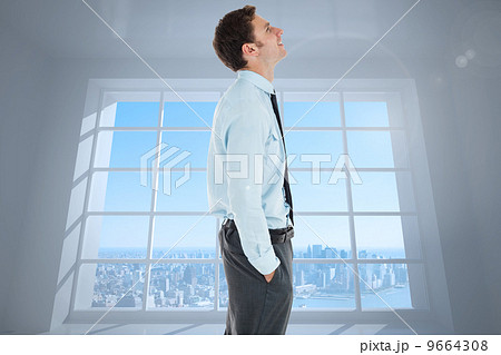 Composite image of happy businessman standing with hand in pocke Composite image of happy businessman standing with hand in pocke 9664308