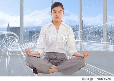 Composite image of businesswoman sitting in lotus pose Composite image of businesswoman sitting in lotus pose 9664520