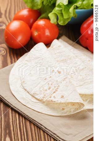 wheat tortillas with vegetables on old wooden table 9666528