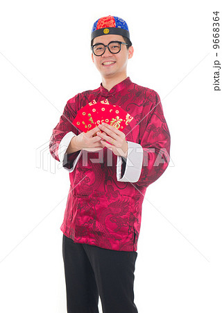 Happy Southeast Asian Chinese male in cheongsam hands holding tw 9668364