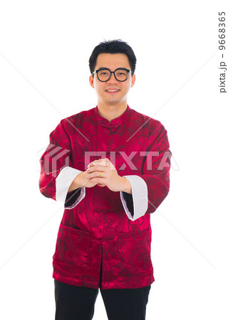Asian man with Chinese traditional dress cheongsam and gong xi f Asian man with Chinese traditional dress cheongsam and gong xi f 9668365