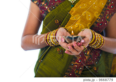 traditional indian female with oil lamp during the celebration o traditional indian female with oil lamp during the celebration o 9668779