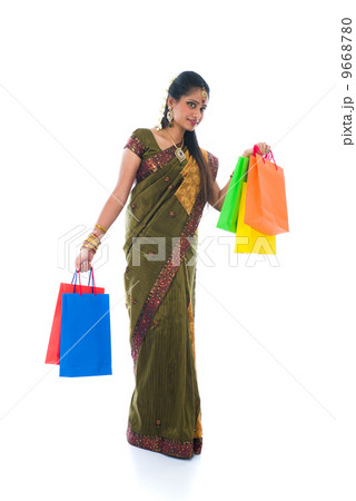 traditional South Indian woman holding Deepavali shopping bags a traditional South Indian woman holding Deepavali shopping bags a 9668780
