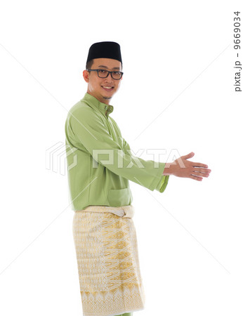 Traditonal Malay man with welcome gesture during ramadan isolate 9669034