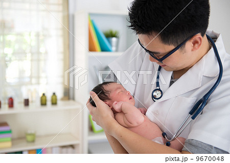 asian male doctor and newborn baby on the clinic 9670048