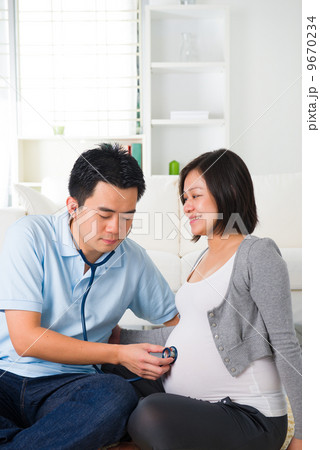 asian chinese pregnant couple lifestyle photo with living room a 9670234