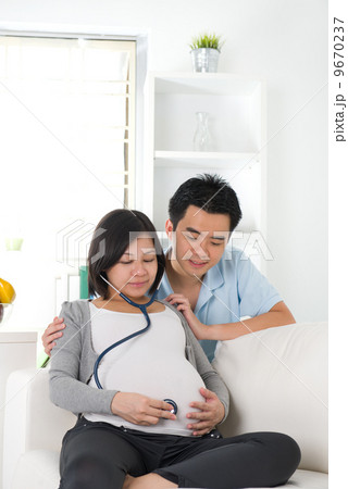 asian chinese pregnant couple lifestyle photo with living room a asian chinese pregnant couple lifestyle photo with living room a 9670237