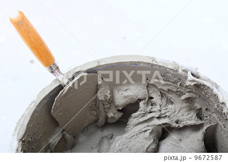 dirty trowel and bucket on building site 9672587
