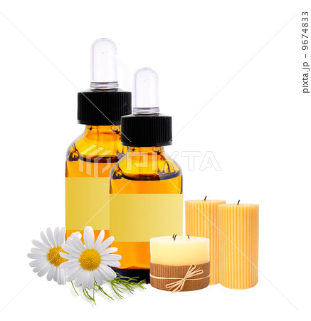 bottles with essence oil, candles and chamomiles bottles with essence oil, candles and chamomiles 9674833