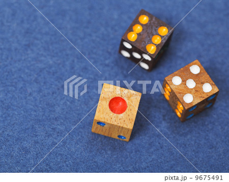 three wooden gambling dices on blue cloth three wooden gambling dices on blue cloth 9675491