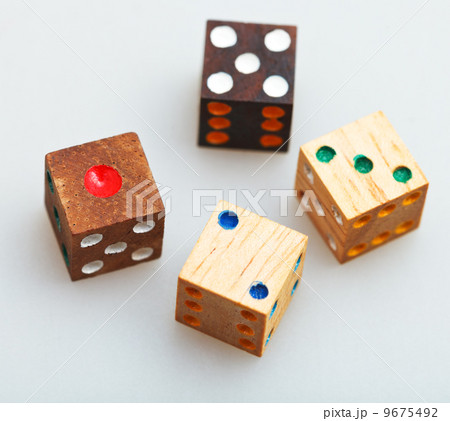 four wooden gambling dices on white table four wooden gambling dices on white table 9675492
