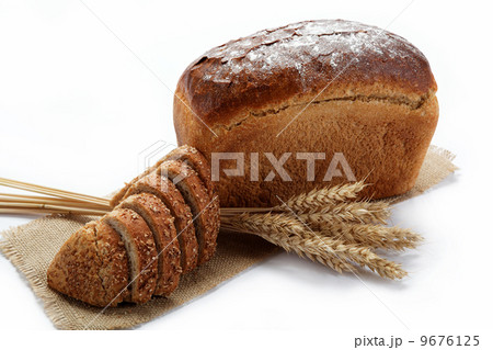Fresh bread with ears of wheat on the canvas. 9676125