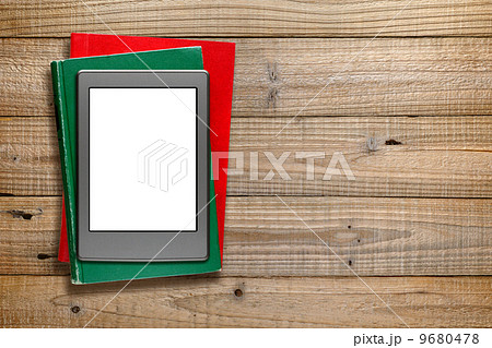 Ereader and old books on wooden background 9680478