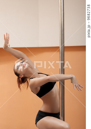 Emotional girl dancing with pylon in studio Emotional girl dancing with pylon in studio 9682738