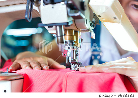 Indonesian Seamstress in Asian textile factory 9683333