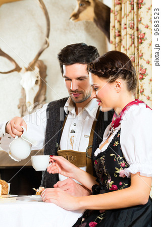 Young couple in a hunter's cabin eating 9683523