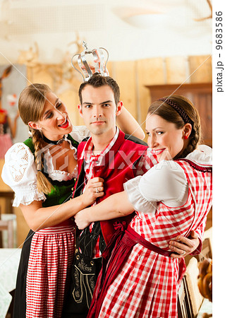 Young people in traditional Bavarian Tracht in restaurant or pub 9683586