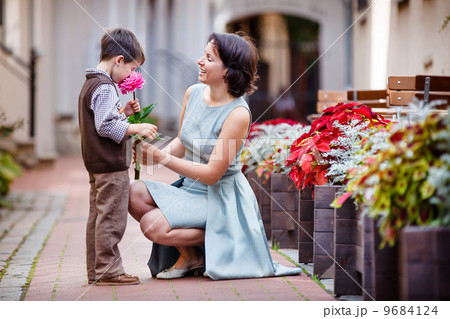 Little boy giving flower to his mom Little boy giving flower to his mom 9684124