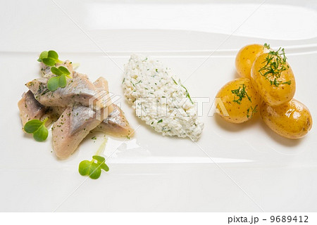Fish slices with potato on a white plate Fish slices with potato on a white plate 9689412