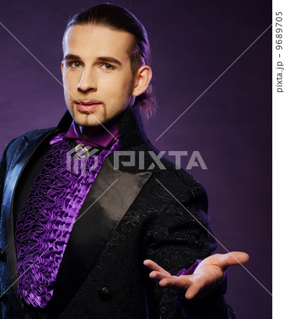 Young handsome brunette magician in stage costume Young handsome brunette magician in stage costume 9689705